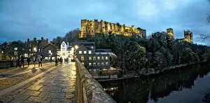 Images Dated 2nd December 2015: Pedestrians Walking On A Walkway Over A River At Dusk With Durham Cathedral And Castle On A
