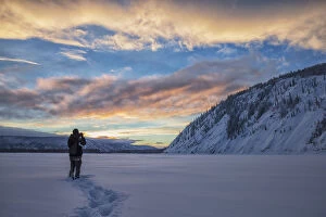 Images Dated 18th January 2014: Photographer Shooting The Sunset Over The Yukon River; Dawson City, Yukon, Canada