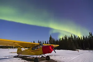 Plane Beneath The Aurora Borealis At The Delta Junction Airstrip; Alaska, United States Of America Plane Beneath The Aurora Borealis At The Delta Junction Airstrip; Alaska, United States Of America