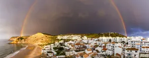 Rainbow arching over the traditional fishing village of Burgau, Algarve, Portugal Rainbow arching over the traditional fishing village of Burgau, Algarve, Portugal