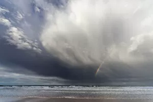 Images Dated 17th September 2011: A Rainbow In The Dark Clouds Over The Ocean; Bamburgh, England