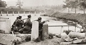 A rearguard remain to prevent the advancing Germans from repairing the bridge blown up by the retreating Belgians at A rearguard remain to prevent the advancing Germans from repairing the bridge blown up by the retreating Belgians at