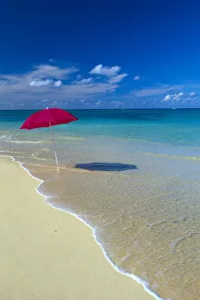 Images Dated 17th October 1996: Red Beach Umbrella In Shoreline Waters, Clear Turquoise Water B1455