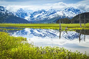 Reflection of Chugach Mountains in a tranquil lake in Alaska Reflection of Chugach Mountains in a tranquil lake in Alaska