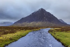 River Etive and mountain range Buachaille Etive Mo with cloudy sky at Glen Coe in Scotland, United Kingdom River Etive and mountain range Buachaille Etive Mo with cloudy sky at Glen Coe in Scotland, United Kingdom