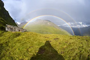 Shadow of a man looking at rainbow over mountain landscape at Kaiser Franz Josefs Hohe in Grossglockner High Alpine Shadow of a man looking at rainbow over mountain landscape at Kaiser Franz Josefs Hohe in Grossglockner High Alpine