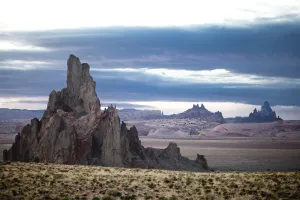 Ship rock stands on the horizon with a similar rock in the foreground Ship rock stands on the horizon with a similar rock in the foreground