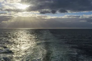 Ship's wake with sun shining through the clouds over the North Sea, United Kingdom Ship's wake with sun shining through the clouds over the North Sea, United Kingdom