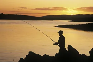 Silhouette Of A Fisherman Fishing On The Coast, Roaring Water Bay, County Cork, Republic Of Ireland Silhouette Of A Fisherman Fishing On The Coast, Roaring Water Bay, County Cork, Republic Of Ireland
