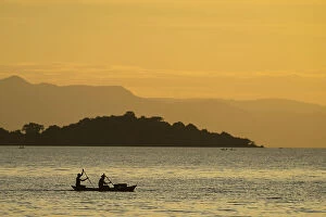 Images Dated 11th April 2014: Silhouette Of Fishermen In Dugout Canoe Leaving Cape Maclear In The Evening, Lake Malawi; Malawi