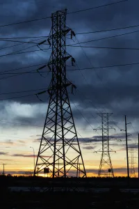 Silhouette Of Large Metal Powerline Towers With Glowing Sky; Calgary, Alberta, Canada Silhouette Of Large Metal Powerline Towers With Glowing Sky; Calgary, Alberta, Canada