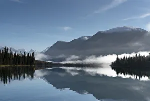 Silhouetted mountains reflected in the calm water of Kontrashibuna Lake in Lake Clark National Park; Alaska Silhouetted mountains reflected in the calm water of Kontrashibuna Lake in Lake Clark National Park; Alaska
