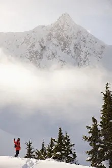 Snowboarder On A Ridge With Scenic Mountains And Fog In The Background, Haines, Southeast Alaska Snowboarder On A Ridge With Scenic Mountains And Fog In The Background, Haines, Southeast Alaska