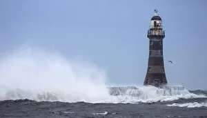 Images Dated 23rd March 2013: Splashing water from a crashing wave against a lighthouse; Sunderland Tyne and Wear England