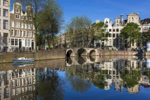 Stone bridge crossing the Herengracht on a sunny day in Amsterdam, Holland Stone bridge crossing the Herengracht on a sunny day in Amsterdam, Holland
