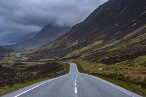 Storm clouds and typical Scottish country road through the highlands, Scotland, United Kingdom Storm clouds and typical Scottish country road through the highlands, Scotland, United Kingdom