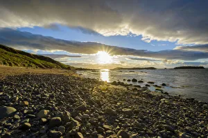 East Lothian Gallery: Sun shining over bay with rocky beach at sunset in North Berwick at Firth of Forth in Scotland