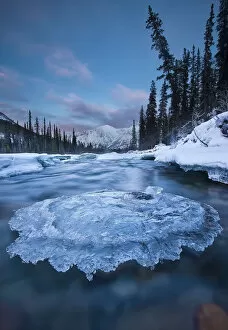Sunset Over Ice-Covered Rock In Wheaton River; Yukon Canada