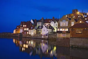 UK, Yorkshire, Houses reflecting in water at dusk; Whitby UK, Yorkshire, Houses reflecting in water at dusk; Whitby