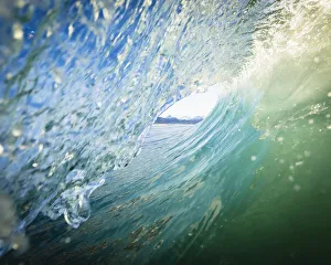 View Through The Barrel Of A Wave To The Kenai Mountains And The Coastline; Homer, Alaska, United States Of America View Through The Barrel Of A Wave To The Kenai Mountains And The Coastline; Homer, Alaska, United States Of America