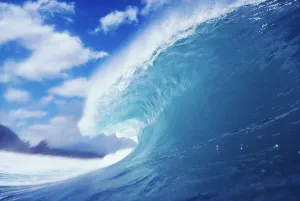 Side View Of Blue, Curling Wave, Background Blurred By Mist Side View Of Blue, Curling Wave, Background Blurred By Mist