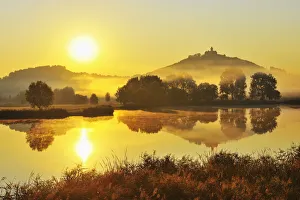 Wachsenburg Castle with Morning Mist and Sun reflecting in Lake at Dawn, Drei Gleichen, Thuringia, Germany Wachsenburg Castle with Morning Mist and Sun reflecting in Lake at Dawn, Drei Gleichen, Thuringia, Germany