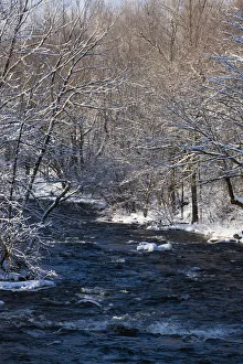 Water Flowing In A River With Snow Covered Shoreline; Fulford, Quebec, Canada Water Flowing In A River With Snow Covered Shoreline; Fulford, Quebec, Canada