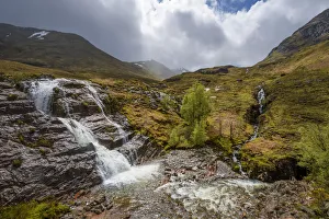 Waterfall in the Scottish Highlands with cloudy sky in Scotland, United Kingdom Waterfall in the Scottish Highlands with cloudy sky in Scotland, United Kingdom