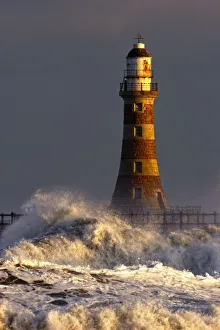 Waves Crashing Against A Lighthouse, Tyne And Wear, England Waves Crashing Against A Lighthouse, Tyne And Wear, England