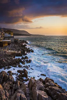 Waves hitting Shoreline at Dusk in Cefalu, Sicily, Italy Waves hitting Shoreline at Dusk in Cefalu, Sicily, Italy