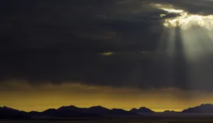 Desert Mountain Scenery Prints: the sun breaks through the clouds in namibia, Namibia