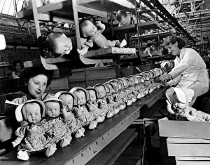 Some of these 1947 dolls for your children are coming off the moving belt Some of these 1947 dolls for your children are coming off the moving belt