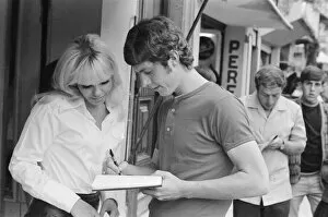 Images Dated 11th May 1970: 1970 World Cup Finals in Mexico. England footballer Brian Kidd signs an autograph