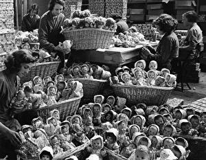 Some of the 2000 dolls that are produced each day in the dressng room. 25th July 1938 Some of the 2000 dolls that are produced each day in the dressng room. 25th July 1938