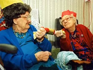 Images Dated 1st November 1994: 97 year olds Alison Lewis and Elizabeth Llewellyn pulling a cracker November