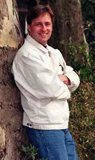 Actor Gary Webster leaning against tree arms folded white jacket and jeans April 1997 Actor Gary Webster leaning against tree arms folded white jacket and jeans April 1997