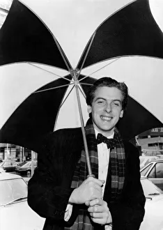 00489 Gallery: Actor Peter Capaldi holding an umbrella. March 1983