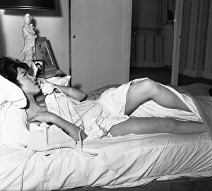 00140 Gallery: Actress Jackie Lane lying naked on the bed talking on the phone March 1959