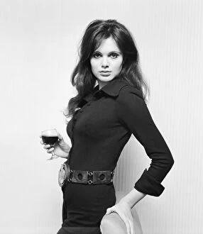 Actress Madeline Smith holding a glass of wine at a BBC Press show reception of