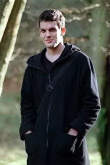 Images Dated 25th January 1999: Adam Sinclair actor January 1999 in park, wearing a black coat, hands in pockets