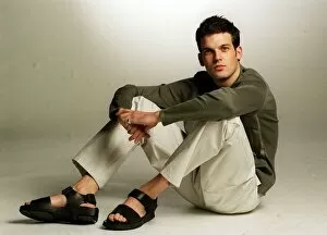 Images Dated 25th January 1999: Adam Sinclair actor in studio January 1999 wearing green jumper cream trousers sandals