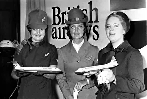 Airline stewardesses use model aircraft to show off the new red Airline stewardesses use model aircraft to show off the new red