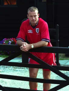 Alan Shearer August 1998 England Football Player standing leaning against fence Alan Shearer August 1998 England Football Player standing leaning against fence