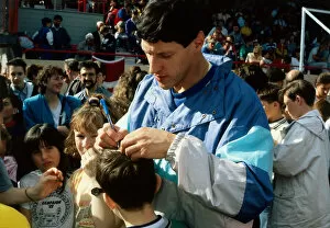 Alan Wells signing autograph on childs head November 1988