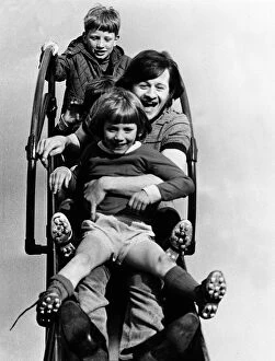 Alex Higgins former World Snooker Champion 1983 with two children holding on to