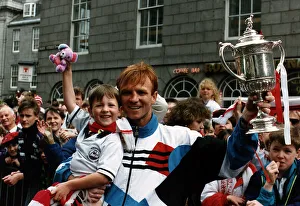 Alex McLeish of Aberdeen Football Club in the street holding up his son in one hand Alex McLeish of Aberdeen Football Club in the street holding up his son in one hand