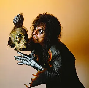 Alice Cooper holding a skeleton head. September 1987 Alice Cooper holding a skeleton head. September 1987