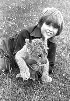 Not all big cats are fearsome as this boy found out with 12 week old lion cub Khan in