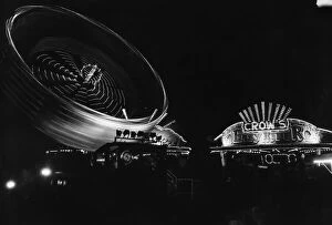 Images Dated 30th August 1980: All the fun of the fair, the bright lights of the big wheel light up the night sky at