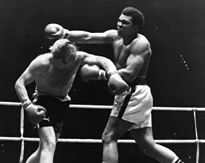 American Heavyweight Champion of the World Muhammad Ali in action against Richard Dunn of American Heavyweight Champion of the World Muhammad Ali in action against Richard Dunn of